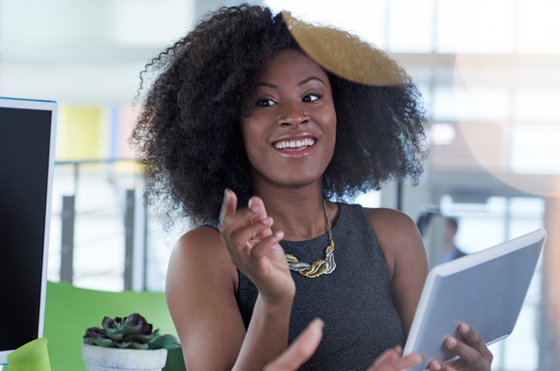 Young african american woman holding tablet