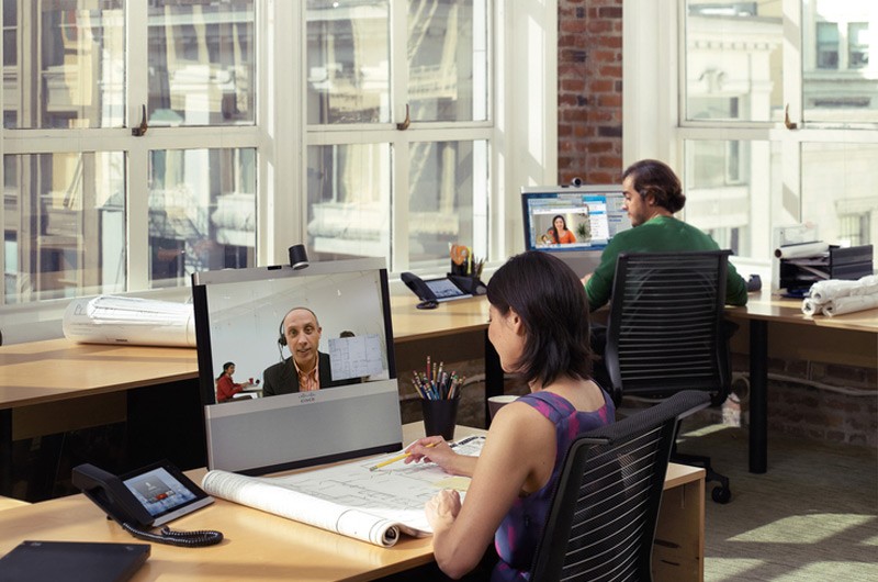Business professionals in modern office highrise with large windows.