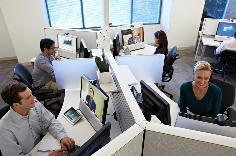 Office cubicles with workers working on their computers.