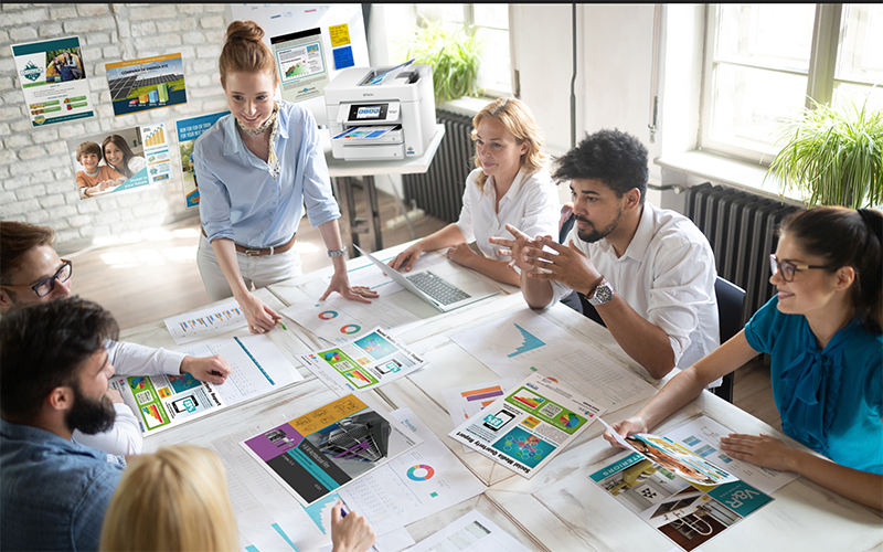 Epson printers Male creative designer printing marketing material at Epson printer