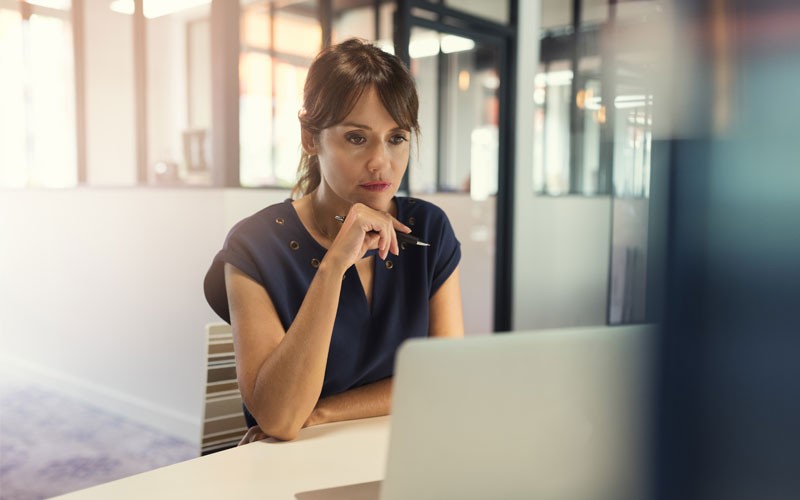 Business woman analyzing computer screen