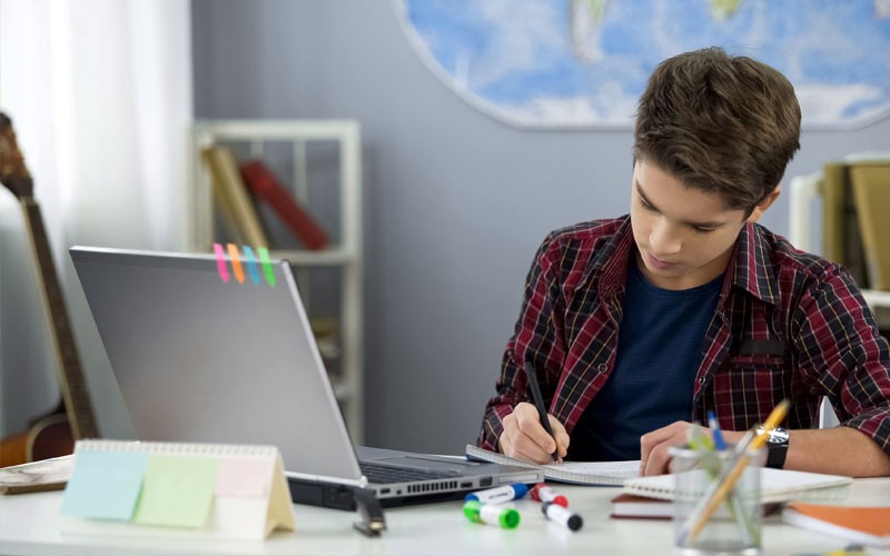 Boy studying in-front of a laptop