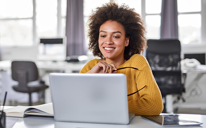woman smiling on laptop