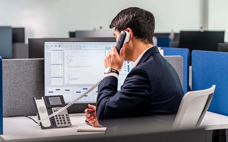 Polycom enterprise-grade, high definition voice solutions Business man using Polycom phone