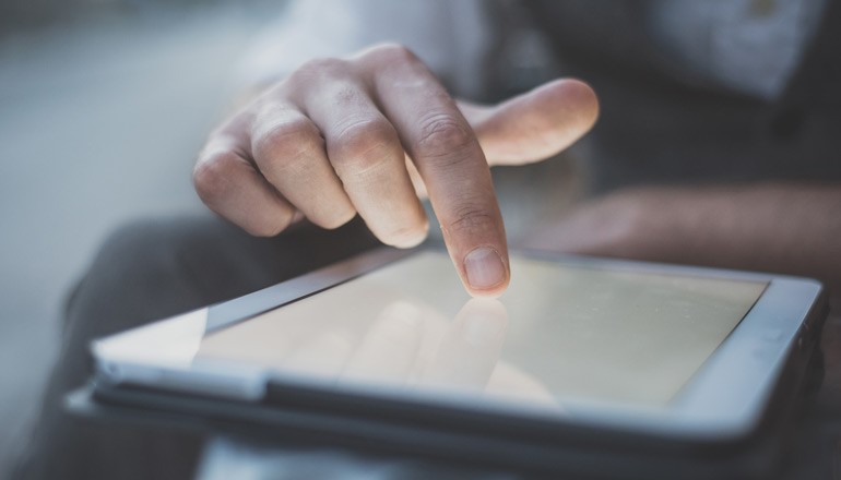 Close up of business professional using tablet computer outside office