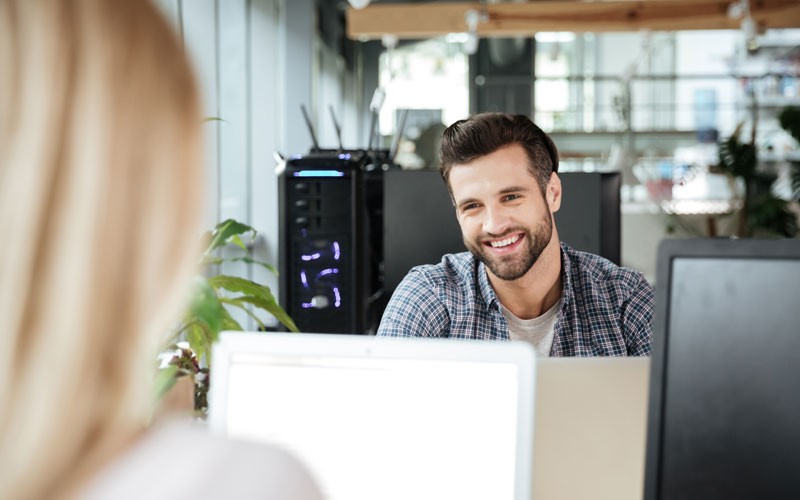 Employee smiling at desk