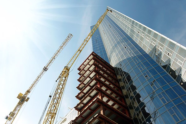 cranes-building-glass-skyscraper cranes-building-glass-skyscraper