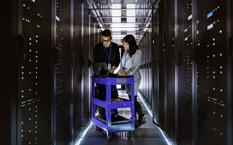 Identify bottlenecks for better performance IT technicians review server information in data center