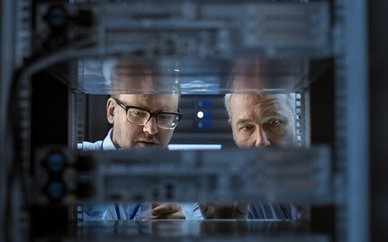 IT engineers work between server racks