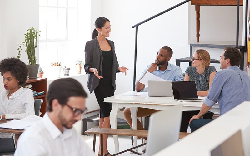 Our staffing services can help you find the right fit Staffing service professionals discuss hiring strategy to team gathered on devices