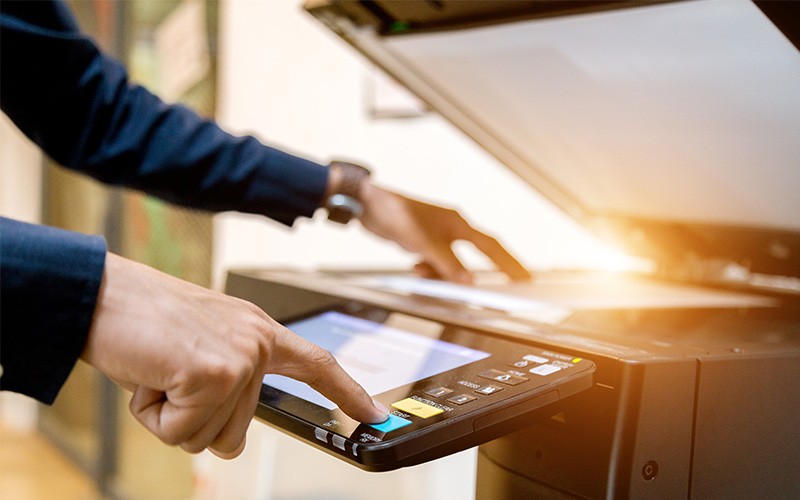 Close up of hands using printer
