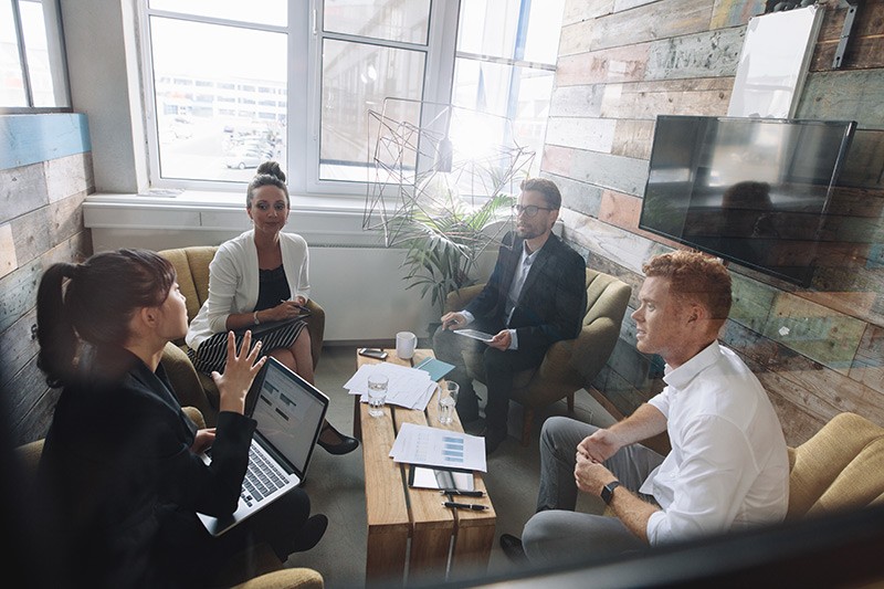 Business team brainstorms solutions in conference room