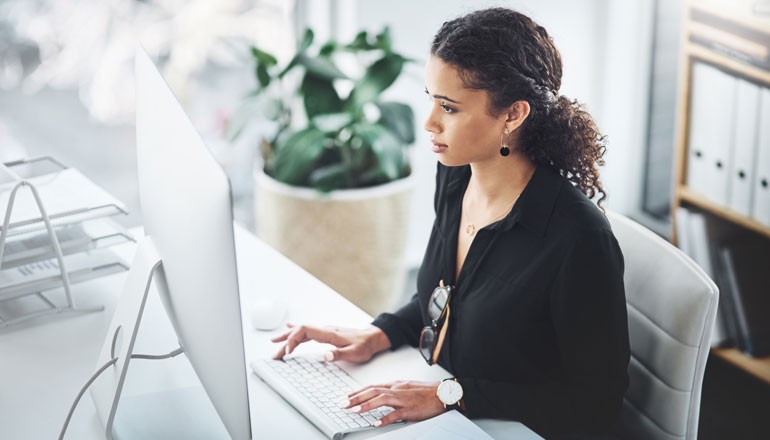 Better financial oversight and counteract potentially significant budget overages Businesswoman on desktop in modern office