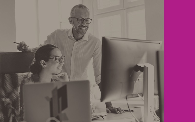 Smiling colleagues use up to date software to complete projects