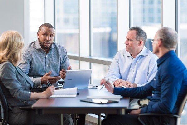 Create a more focused plan for driving efficiencies Business professionals discuss IT road map planning during meeting
