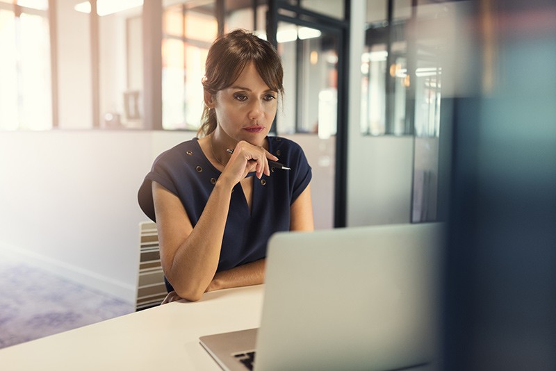 Business woman reviews technology finance options